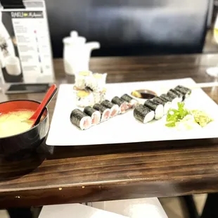 a plate of sushi and a bowl of soup