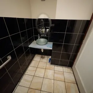 The men&apos;s bathroom was horrible. The vanity was as broken, the walls, door and floor were stained and dirty.