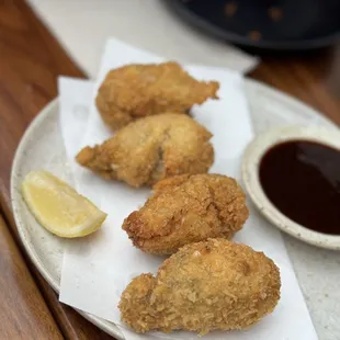 a plate of fried food with dipping sauce