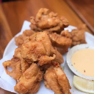 a plate of fried food with dipping sauce