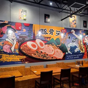 a restaurant with a large mural