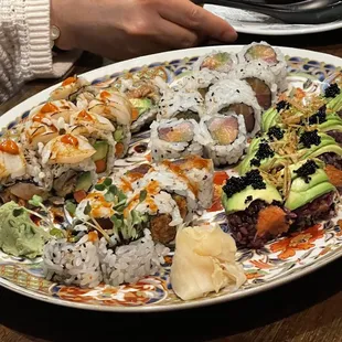 a plate of sushi and vegetables