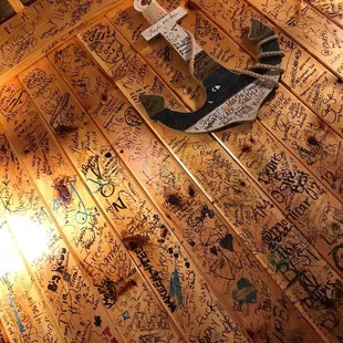 a wooden floor covered in graffiti