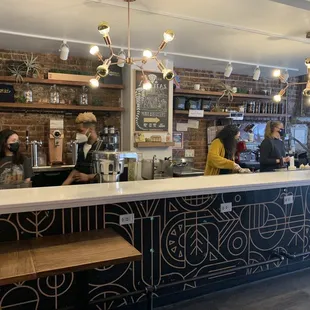 customers at the counter of a coffee shop