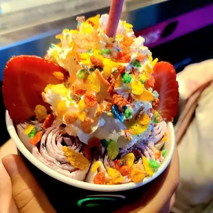 a person holding a bowl of ice cream