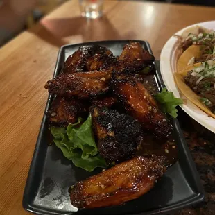 a plate of wings and a salad