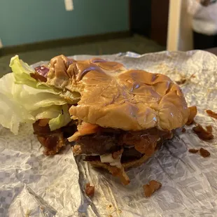 a burger with lettuce and bacon