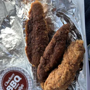 a plate of fried chicken and a cup of bbq