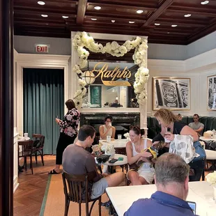 people sitting at tables in a restaurant