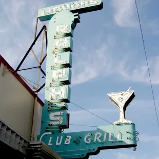the neon sign for the club grill
