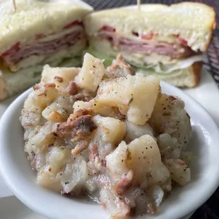 a plate of potato salad and a sandwich