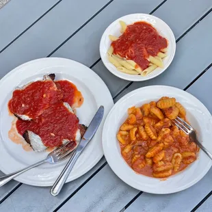 two plates of pasta and meat