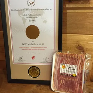 a framed picture of a package of bacon