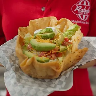 a woman holding a sandwich