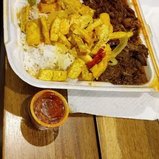 a meal of rice, meat, and vegetables