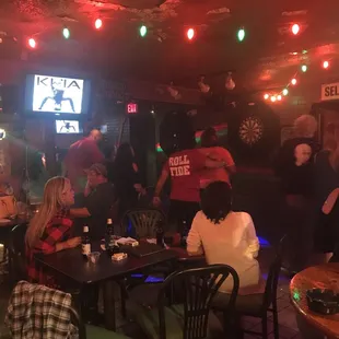  group of people sitting at tables in a bar