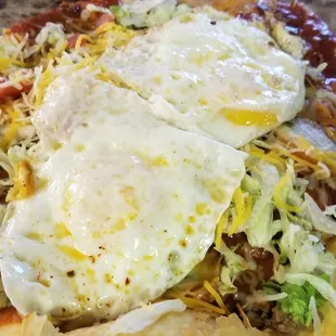 Indian Taco with two eggs over easy. Red chile sauce. May I add it was incredibly delicious!