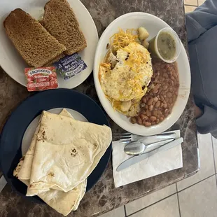 a breakfast of eggs, beans, toast, and bread