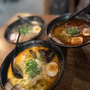 three bowls of ramen and a bowl of soup