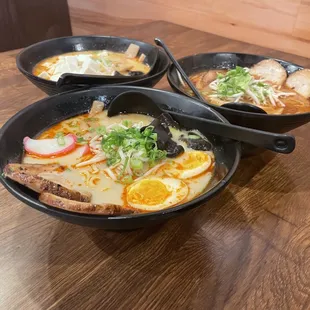 back left: veggie ramen, front: tonkatsu ramen, back right: black garlic ramen