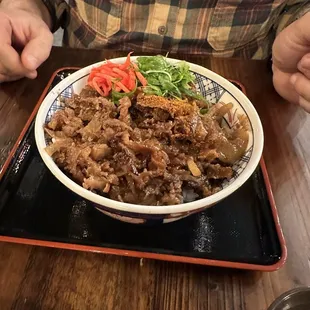 a man sitting at a table with a plate of food