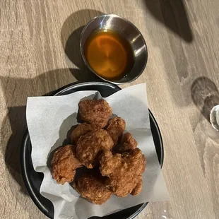 a bowl of soup and a plate of fried chicken nuggies