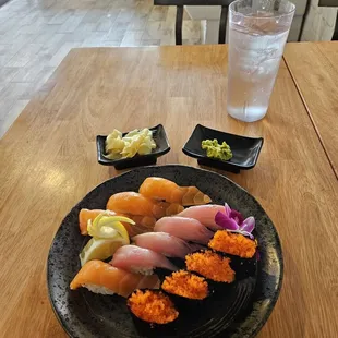 a plate of sushi and a glass of water