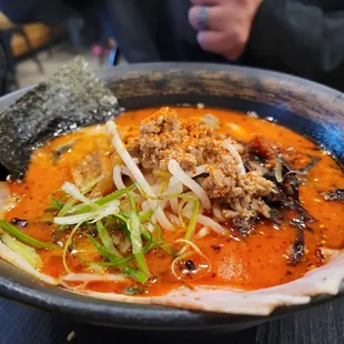 a bowl of ramen with meat and vegetables