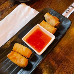 a plate of food with dipping sauce