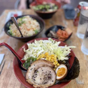 a plate of ramen, rice, and salad