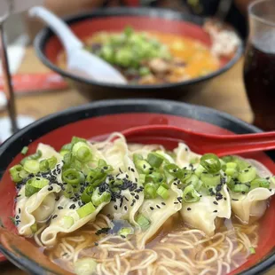 a bowl of ramen with noodles and scallions
