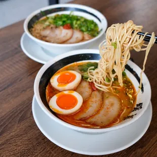 two bowls of ramen with chopsticks