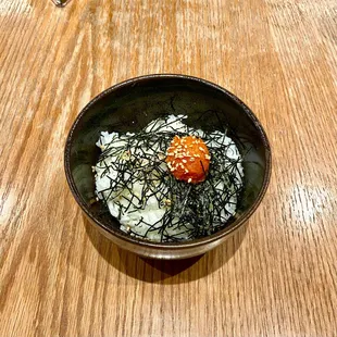 a bowl of food on a wooden table