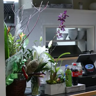 a kitchen counter with a vase of flowers