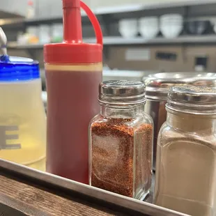 Vinegar, chili oil and spices at table.