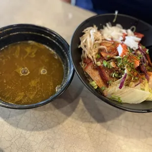 two bowls of soup and a hot dog