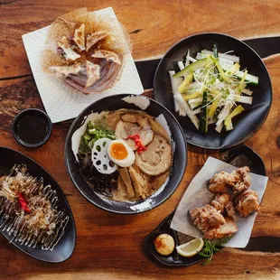 a variety of dishes on a wooden table
