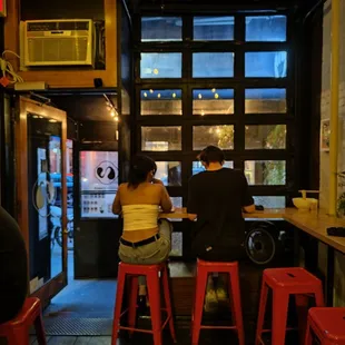 two people sitting at a bar