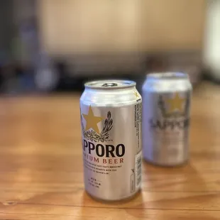 two cans of beer on a table