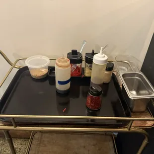 Condiments available in the corner by the kitchen