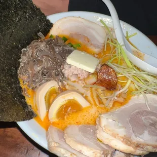 a bowl of ramen and a piece of sushi