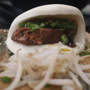 Pork Kakuni Bao Bun with bean sprouts.