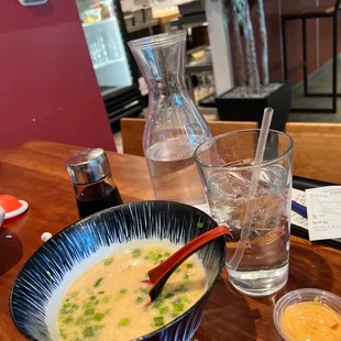 a bowl of soup and a glass of water