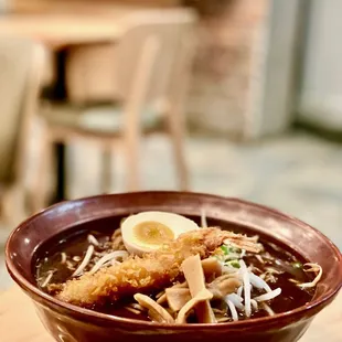 a bowl of ramen and a plate of salad