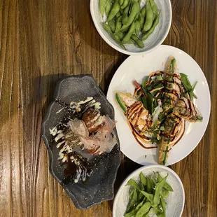 three plates of food on a wooden table
