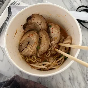 a bowl of ramen and chopsticks