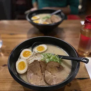  a bowl of ramen with a boiled egg on top