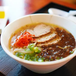 a bowl of ramen with meat and vegetables