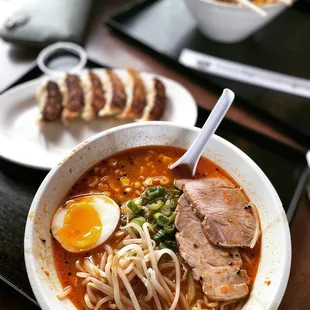 a bowl of ramen with meat and an egg