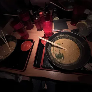 a bowl of ramen and chopsticks on a table